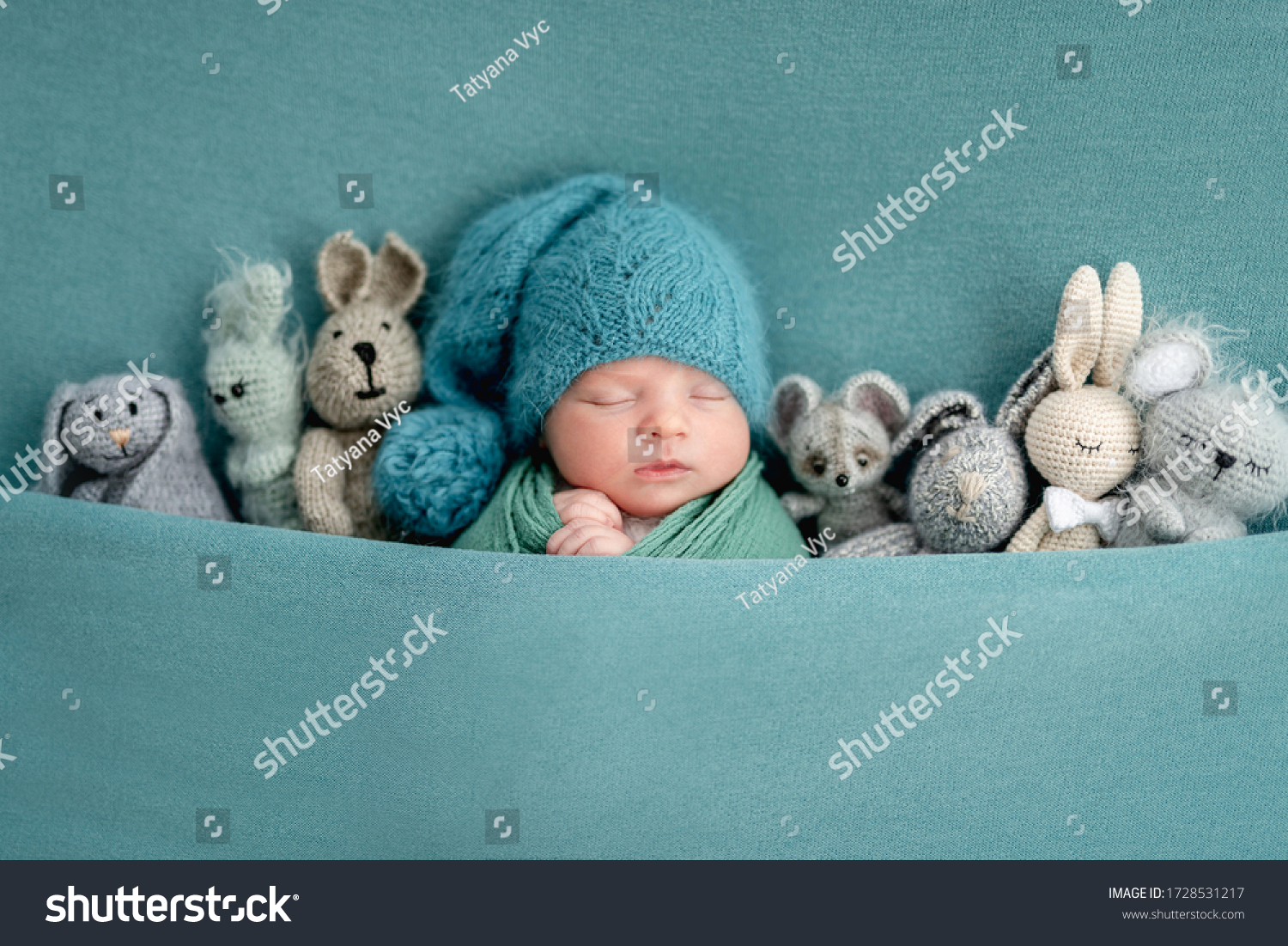 Beautiful newborn sleeping with knitted toys #1728531217