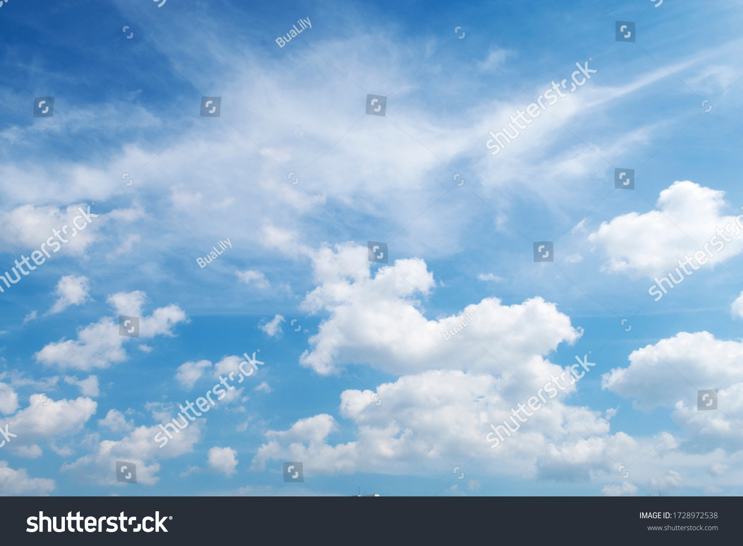 Natural sunny blue sky background with beautiful puffy white cumulus clouds & fluffy cirrus cloudscape on bright daylight horizon in tropical summer sunlight & exotic sun ray at sunny & sunshine day #1728972538