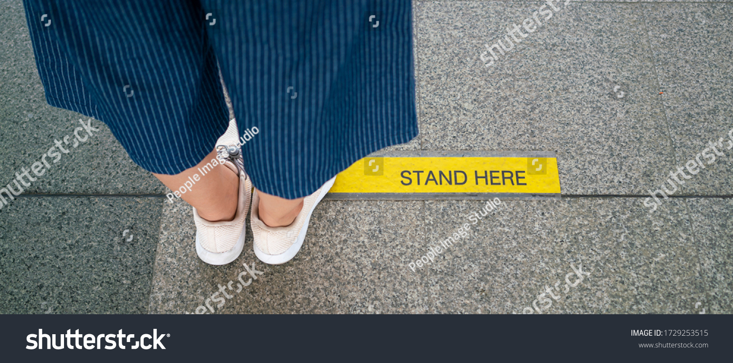 Banner photo of Asian woman standing on social distancing sign for keep distance and queue for entrance subway train a new normal life trend. corona virus, social distancing or new normal concepts #1729253515