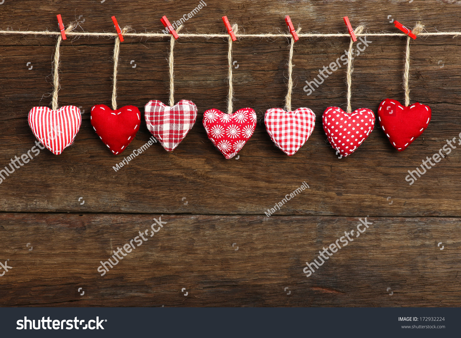 Gingham Love Valentine's hearts natural cord and red clips hanging on rustic driftwood texture background, copy space #172932224