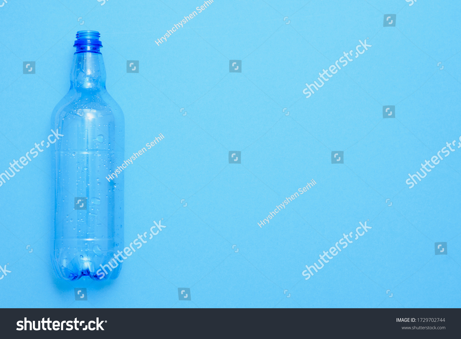 Used plastic bottles on the blue background. Recycling concept #1729702744