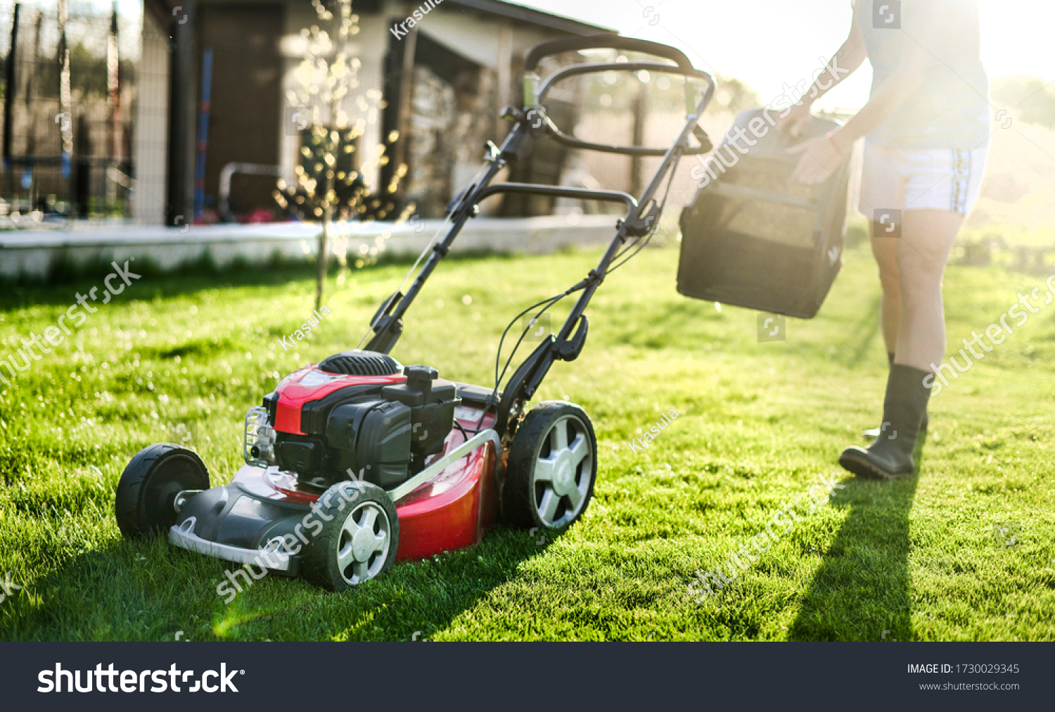 Lawn mover on green grass in modern garden. Machine for cutting lawns. #1730029345