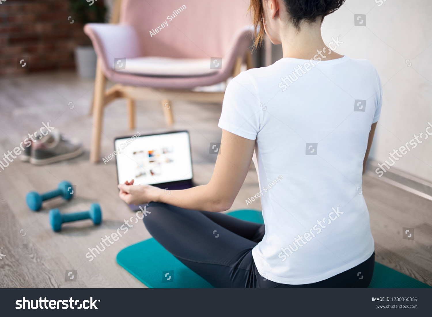 oung sporty slim woman has internet video online fitness training instructor modern laptop screen. Healthy lifestyle concept, online fitness and sport lessons. Stretching online. #1730360359