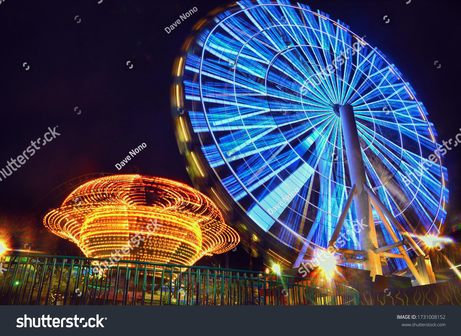 A beauty of a carnival at night. Time lapse photography of a Ferris wheel.  #1731008152