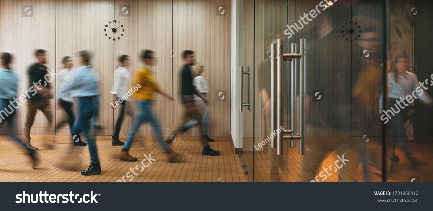 Group of office people walking at office open space. Team of business employees at coworking center. People at motion blur. Concept working at action #1731858412
