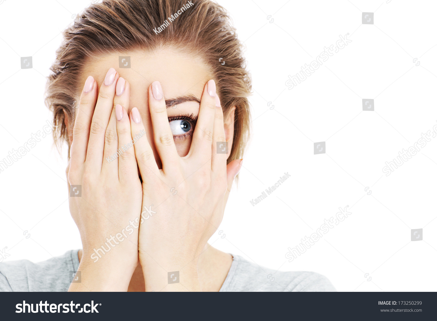 A picture of a scared woman covering her eyes over white background #173250299