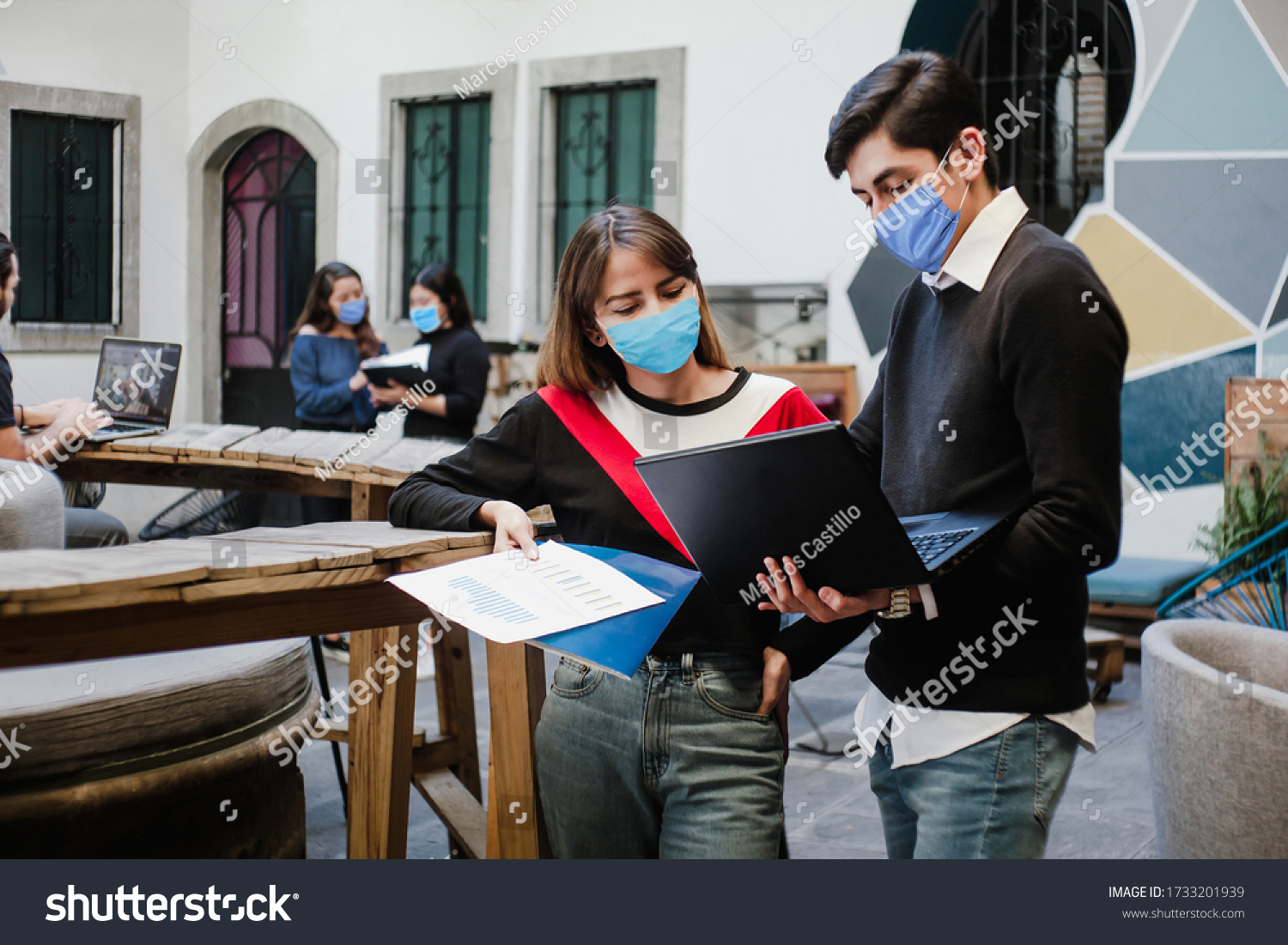 Latin people teamwork working in coworking while wearing face mask for social distancing in new normal situation preventing the infection of corona virus or covid-19, Mexican Coworkers in Mexico #1733201939