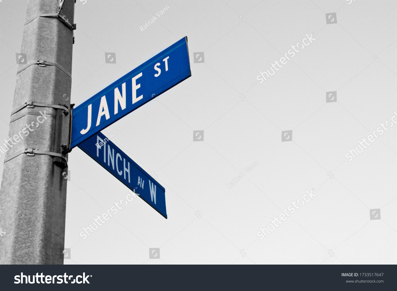 Jane Street and Finch Avenue W street sign at the corner of the intersection. #1733517647