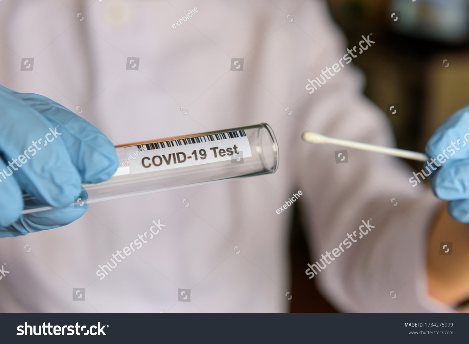 Medical worker holding swab sample collection kit, test tube for performing patient nasal swabbing. Hands in gloves holding testing equipment for Coronavirus COVID-19 diagnostic. #1734275999