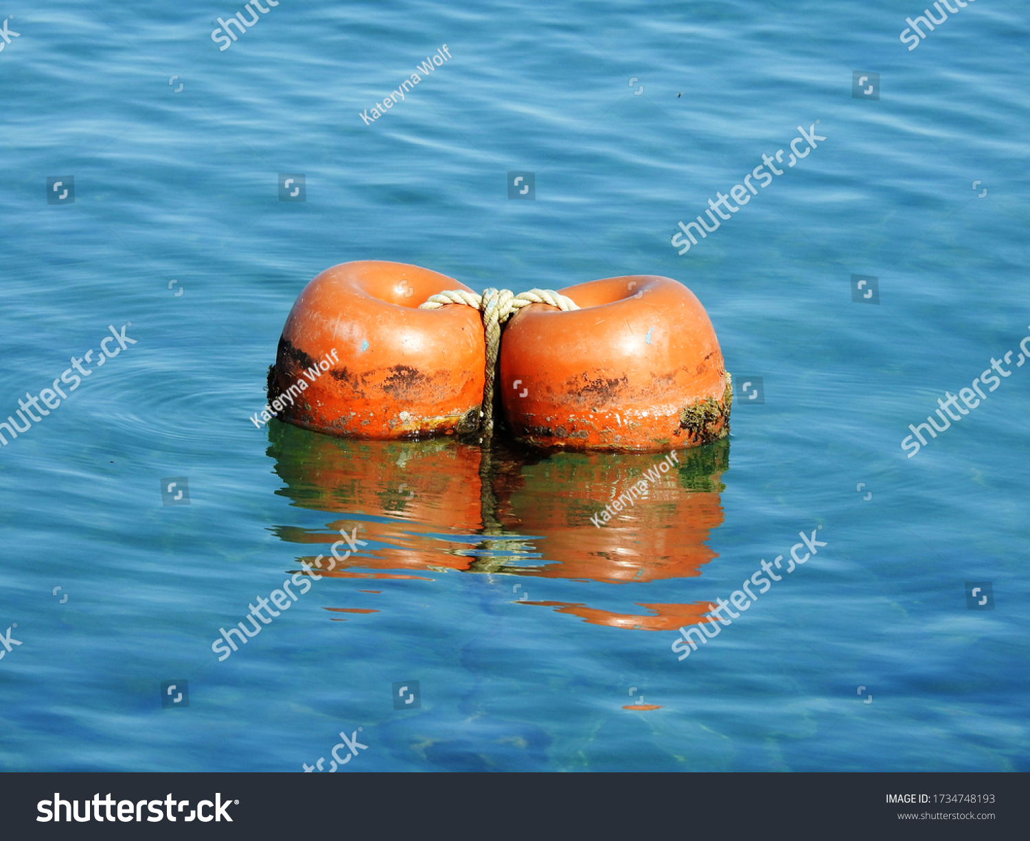 Two floating orange buoys (floats) in the sea #1734748193