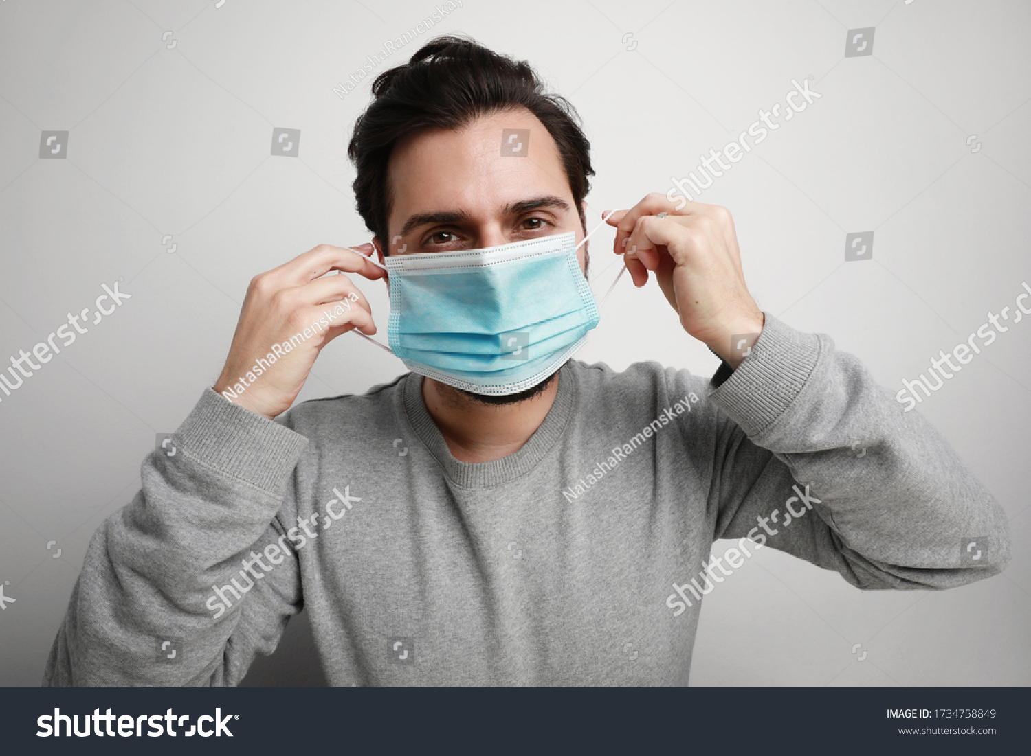 Headshot of young man using medical virus mask protection of coronavirus. Worldwide pandemic situation. #1734758849