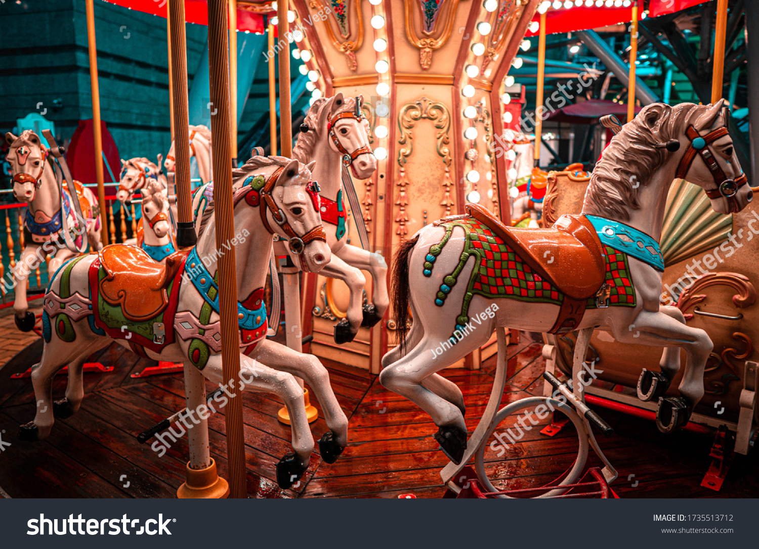 A night shot of a merry Go round, on a rainy night.  #1735513712