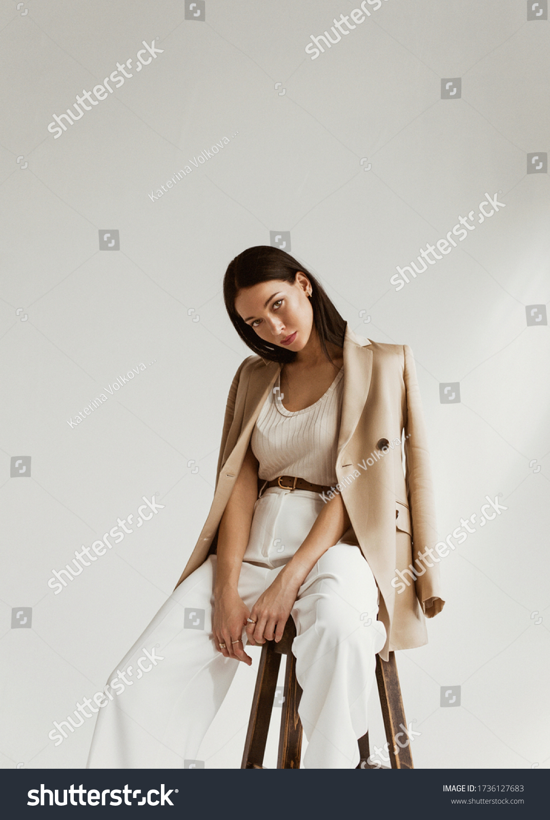girl in a beige jacket fashion on a white background #1736127683