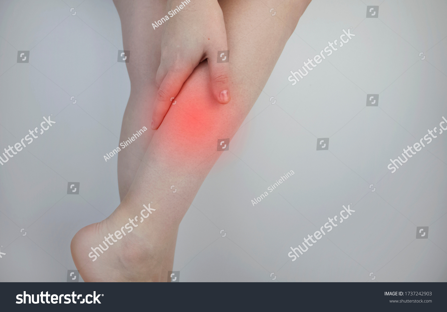 A woman suffers from pain in the calves. Stretching the calf muscle, varicose veins, leg cramps, or myositis. Orthopedic doctor examines patient #1737242903