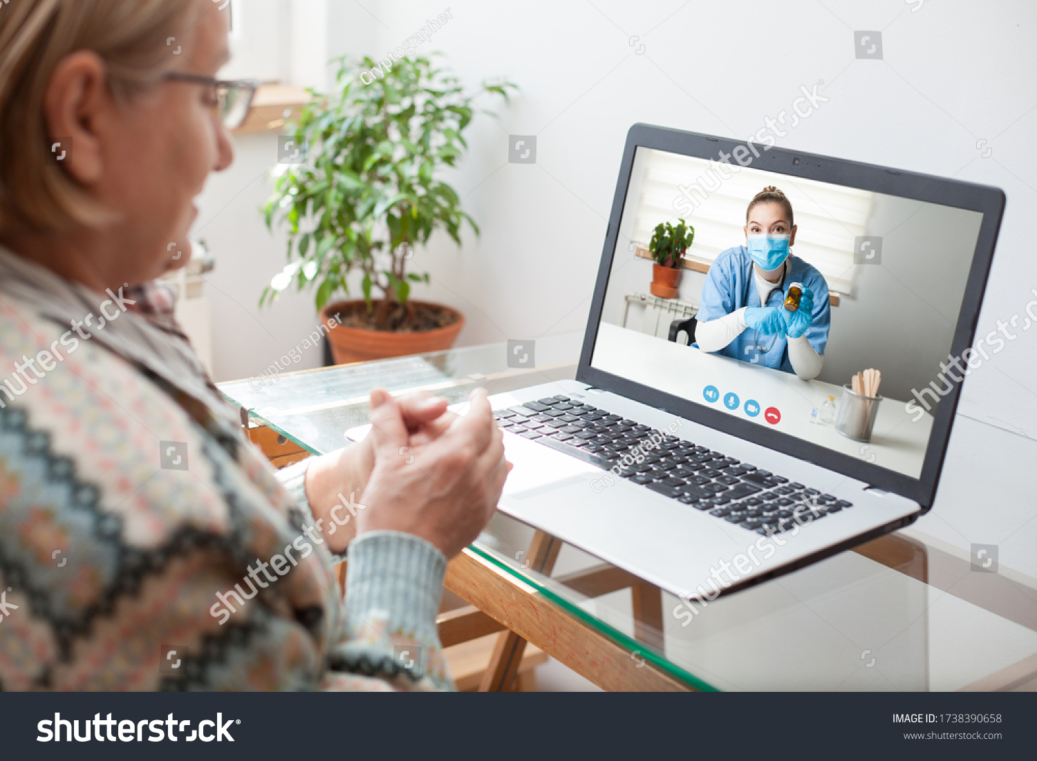 Young female doctor consulting with elderly woman over video help line virtual medical appointment chat,GP prescribing medication to senior patient,telemedicine diagnosis,therapy and treatment concept #1738390658