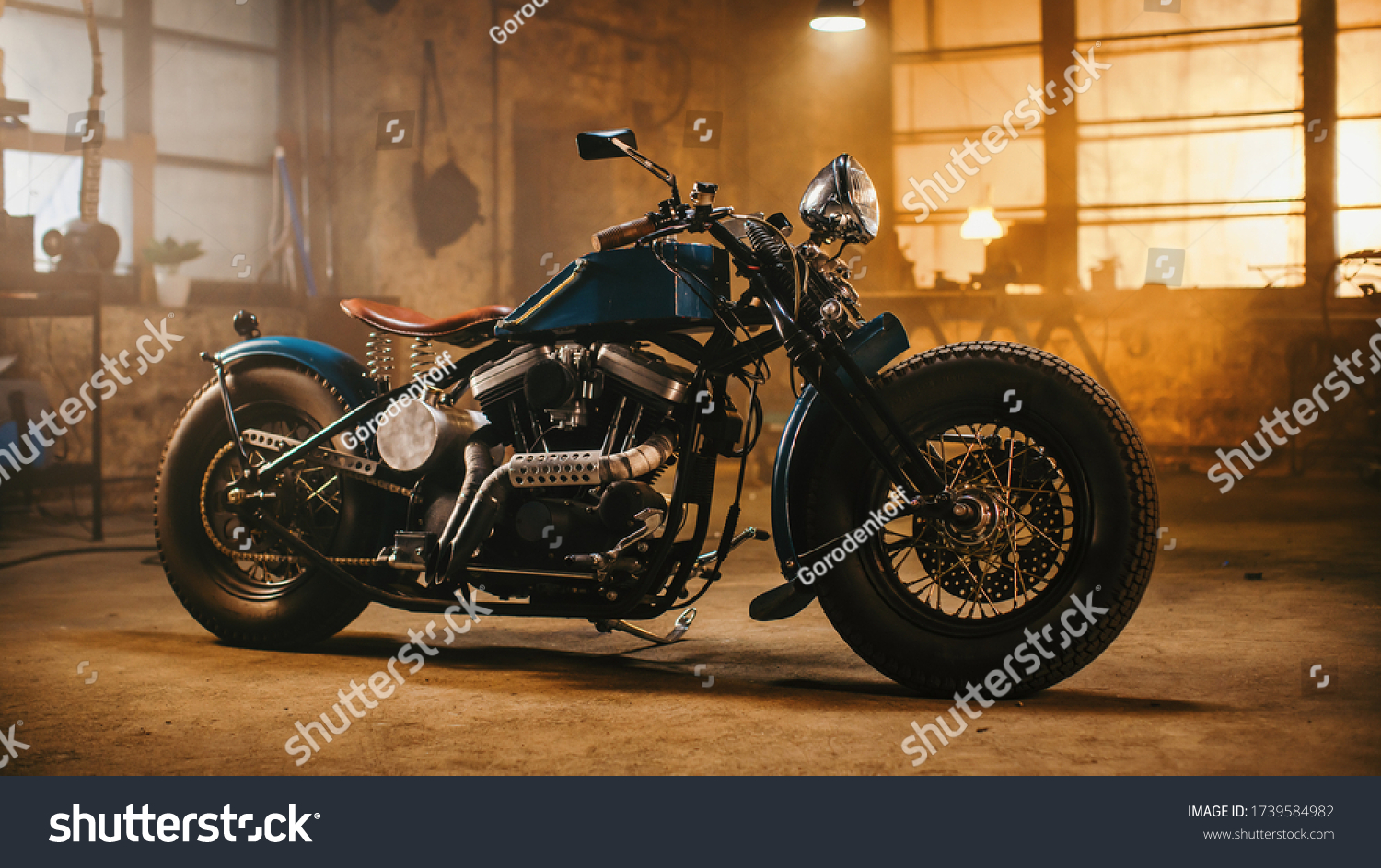 Custom Bobber Motorbike Standing in an Authentic Creative Workshop. Vintage Style Motorcycle Under Warm Lamp Light in a Garage. #1739584982