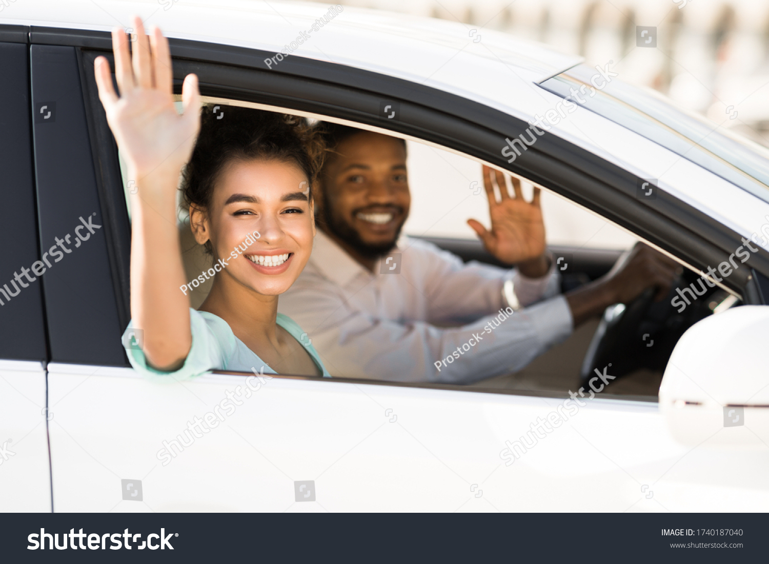 Car Trip. Happy African American Couple Waving Good Bye Sitting In Auto During Ride. Selective Focus #1740187040