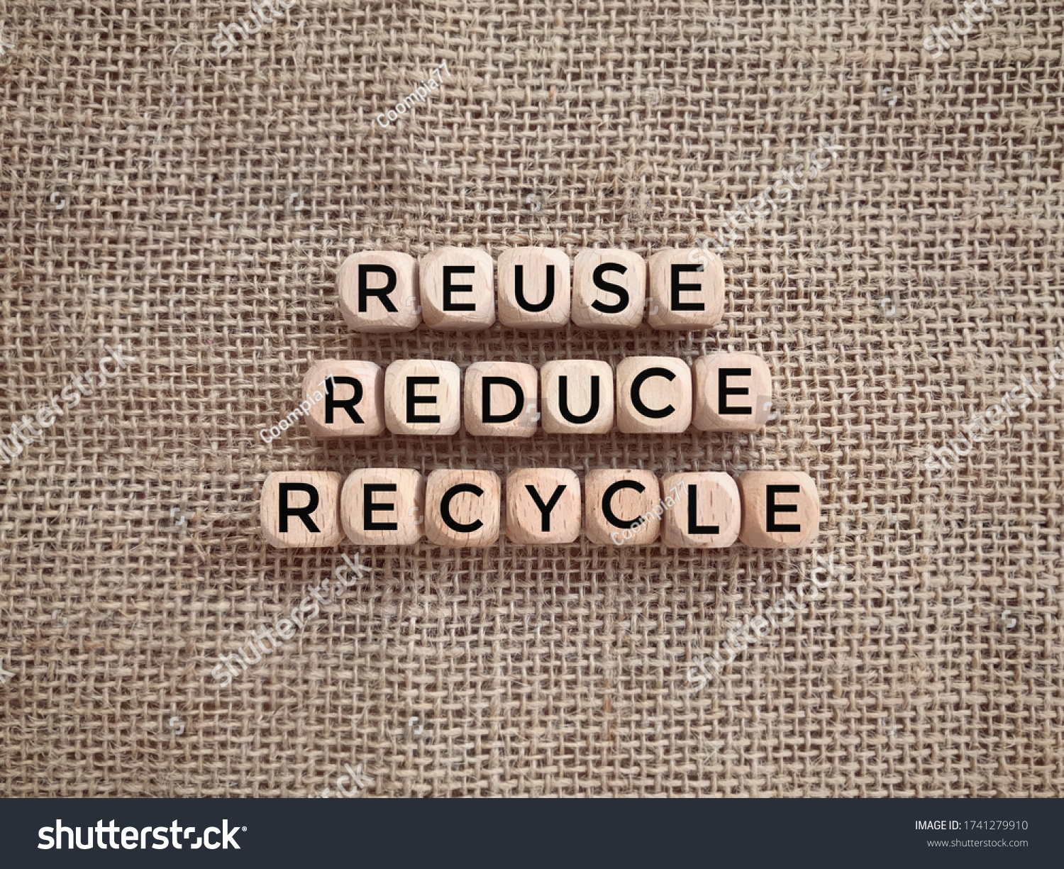 Environmental awareness and educational concept. REUSE, REDUCE and RECYCLE written on wooden blocks. #1741279910