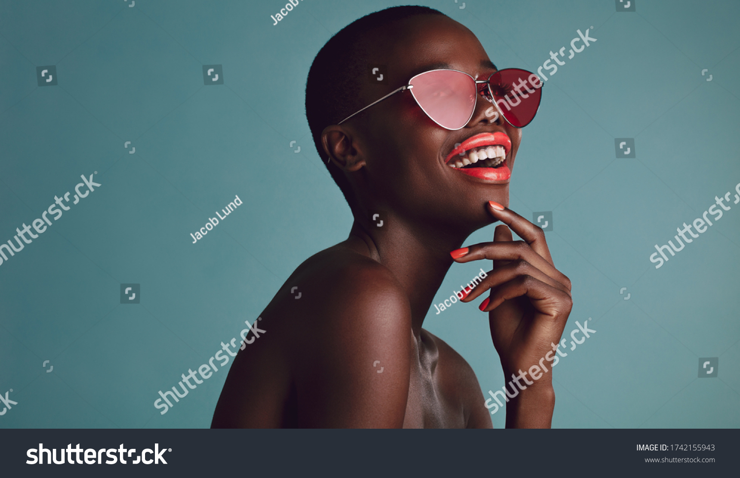 Close up shot of beautiful woman in sunglasses and red lips against grey background. African female model with funky sunglasses. #1742155943