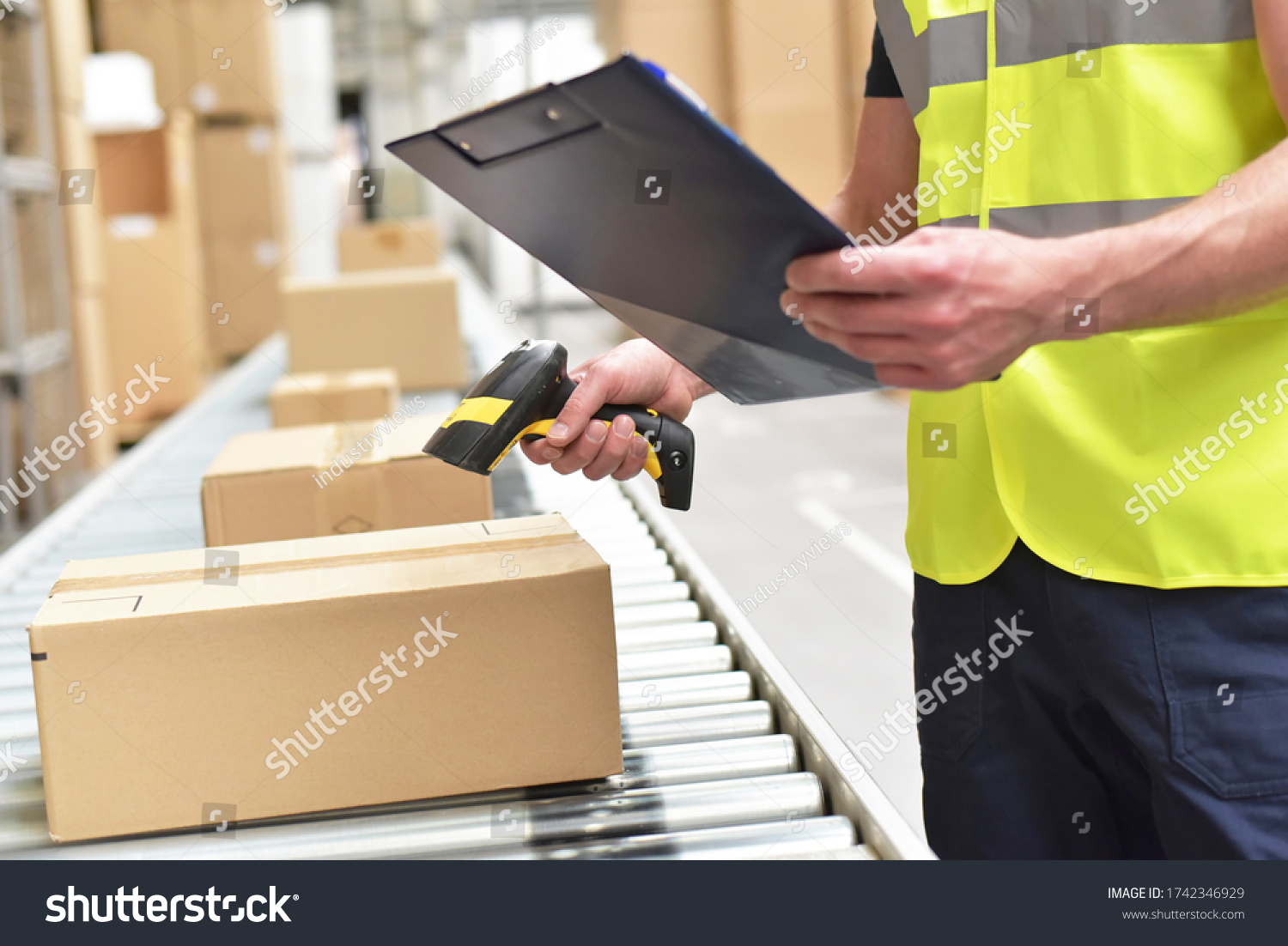 workers in the warehouse scanning parcels for retail and transport shipping  #1742346929