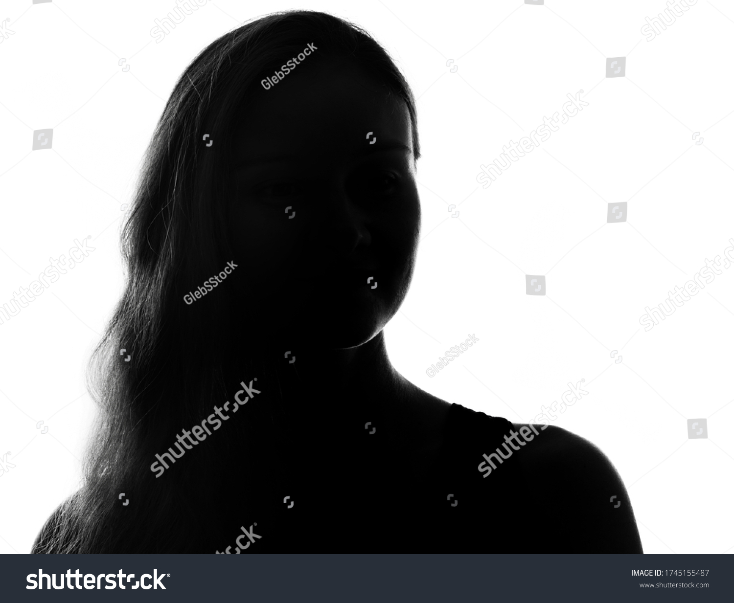 Female person silhouette in the shadow, back lit light #1745155487
