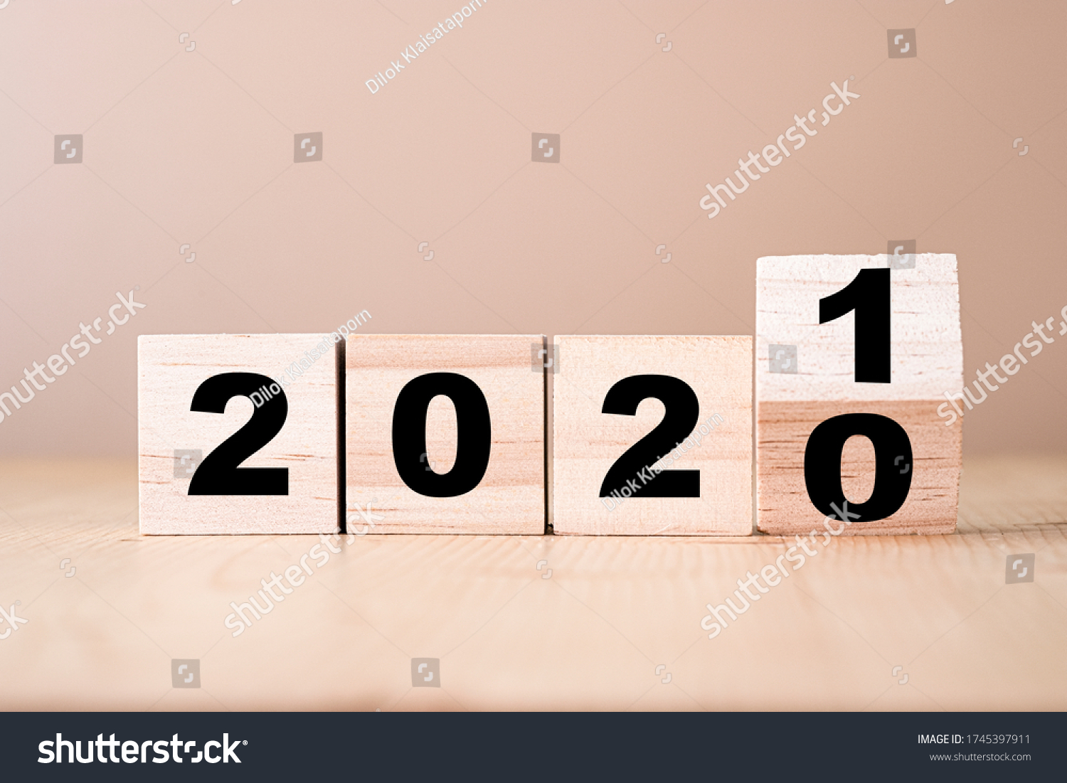 Hand flipping wooden blocks for change year  2020 to 2021 . New year and holiday concept. #1745397911