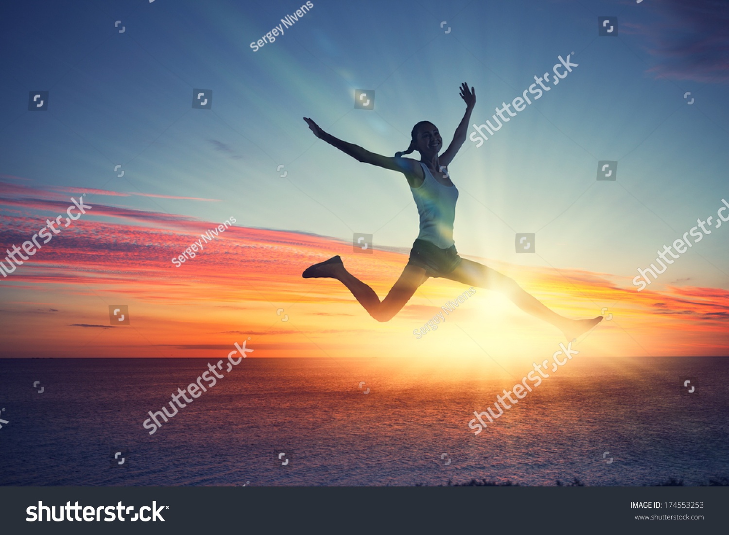 Silhouette of dancer jumping against city in lights of sunrise #174553253