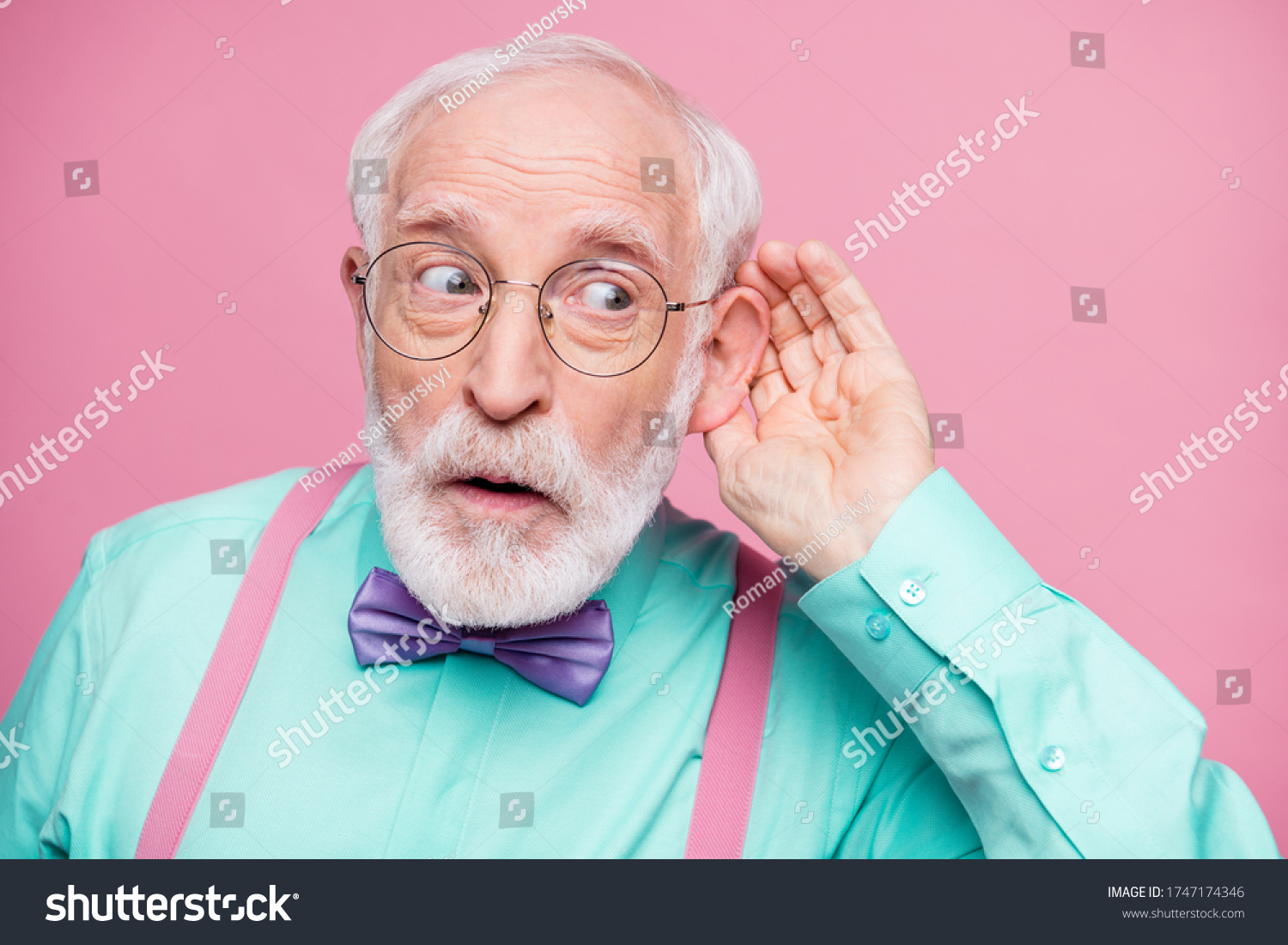 Closeup photo of attractive grandpa hand near ear listen rumors focused chatterbox bad person wear specs mint shirt suspenders violet bow tie isolated pink pastel color background #1747174346