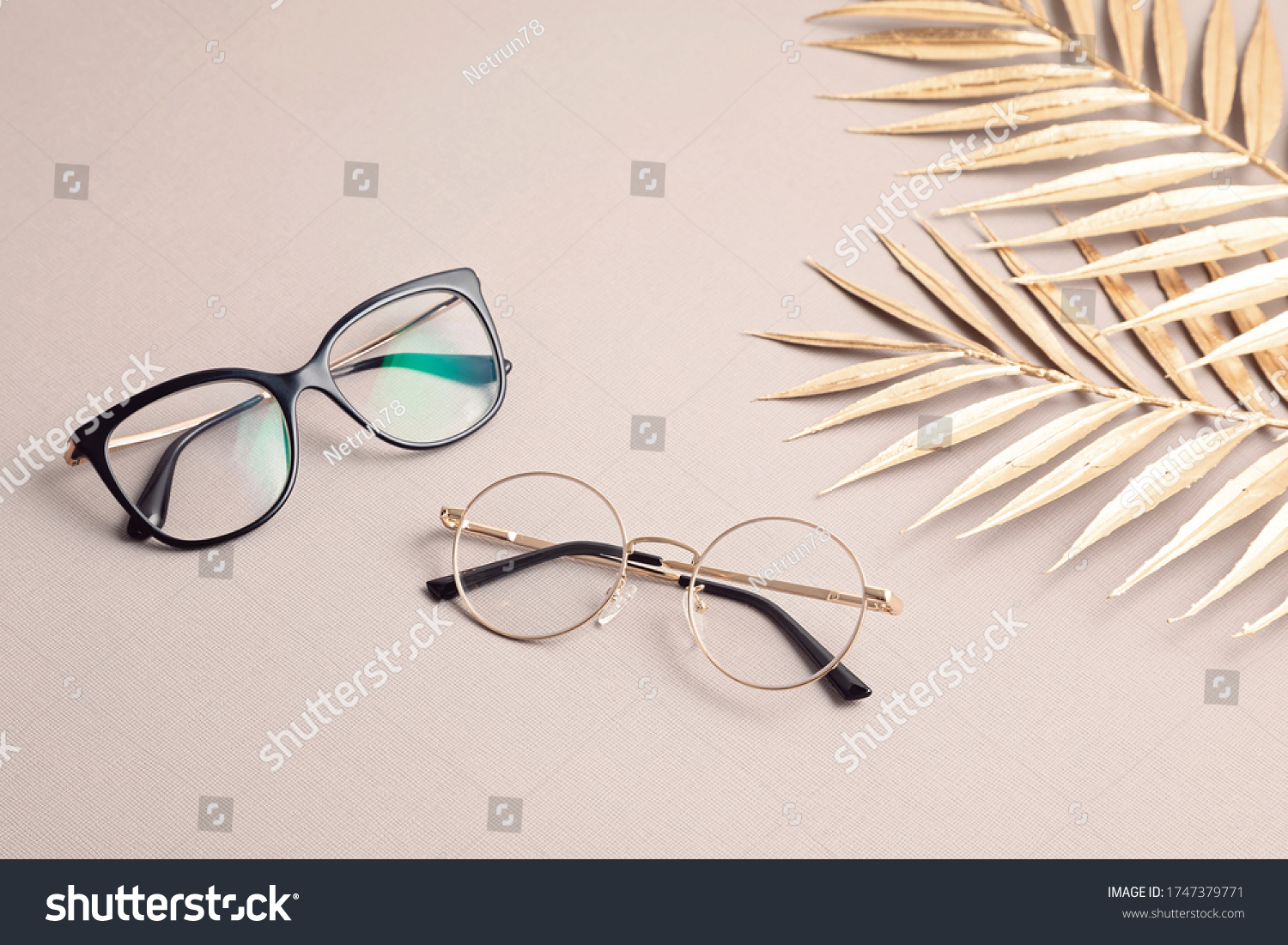 Stylish eyeglasses over pastel  background. Optical store, glasses selection, eye test, vision examination at optician, fashion accessories concept. Top view, flat lay #1747379771