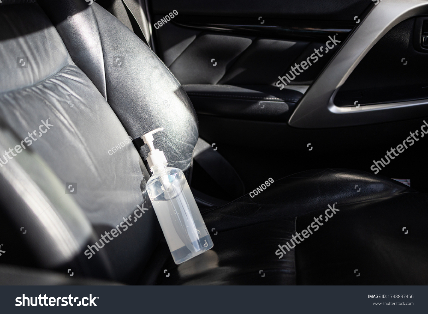 Hand sanitizer placed on car seat and exposed to sun in sunny day,do not keep alcohol antiseptic gel in the car,could start a fire,flammable objects,cause danger if parked in the sunshine,very hot day #1748897456