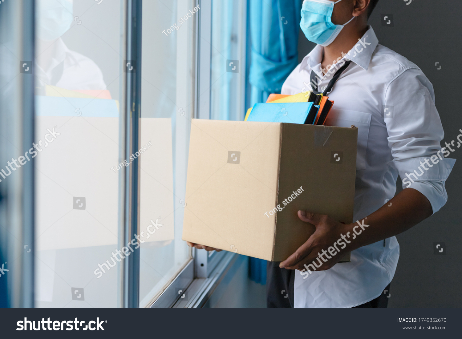 Asian unemployed person holds the document box by the window in hope, Unemployment in the Covid Virus Crisis 19. Business Failure Crisis was laid off from unemployment.  #1749352670
