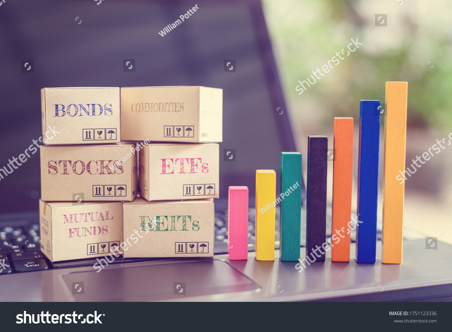 Online asset investment / portfolio diversification management for long-term profit growth concept : Boxes of financial products e.g bonds, commodities, stocks, mutual funds, ETFs, REITs on a laptop #1751123336