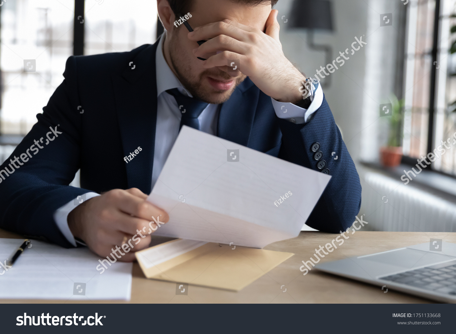 Upset male employer or boss sit at desk feel distressed disappointed reading post paper correspondence, unhappy employee frustrated by postal paperwork, get dismissal notice, fired, failure concept #1751133668