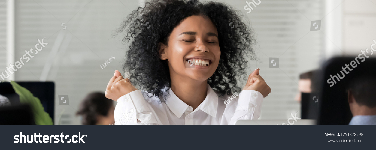 Excited African employee sitting in office received long awaited great news feels happy, reward, job advancement, promotion and career growth concept. Horizontal photo banner for website header design #1751378798