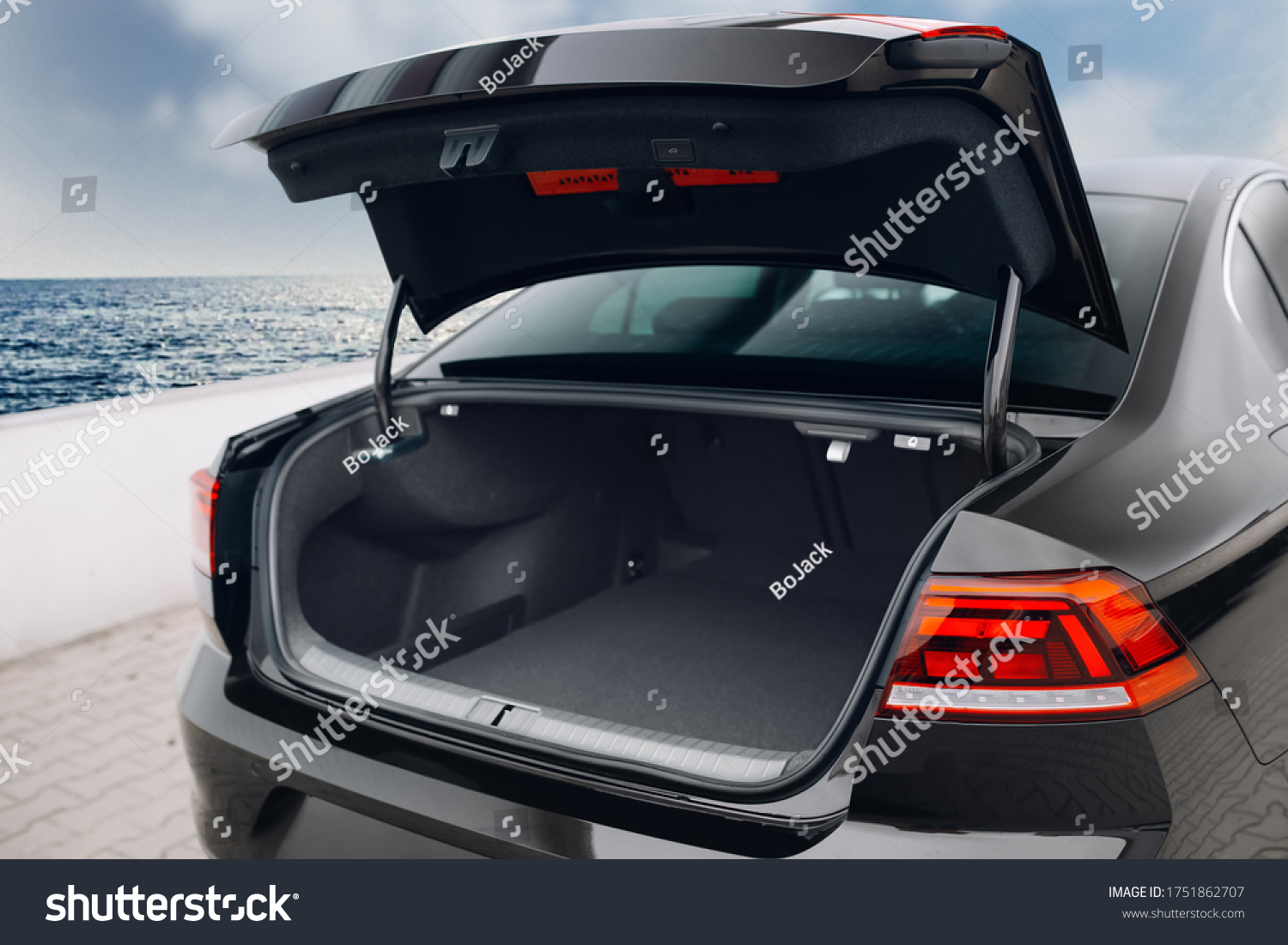 Modern sedan car have an open trunk. The car boot is open and ready for luggage loading. Empty space at the boot of the sedan car. Rental car service #1751862707