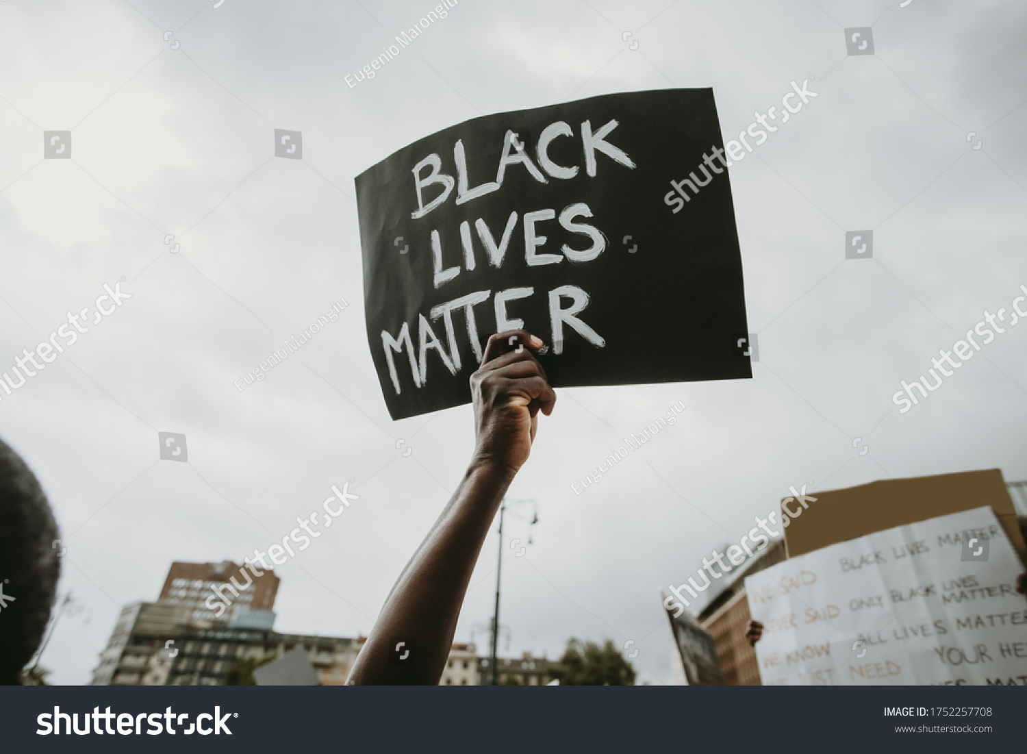  Black lives matter movement protesting in Milan, claiming for antiracism and equal human rights holding "Black lives matter" picket sign #1752257708
