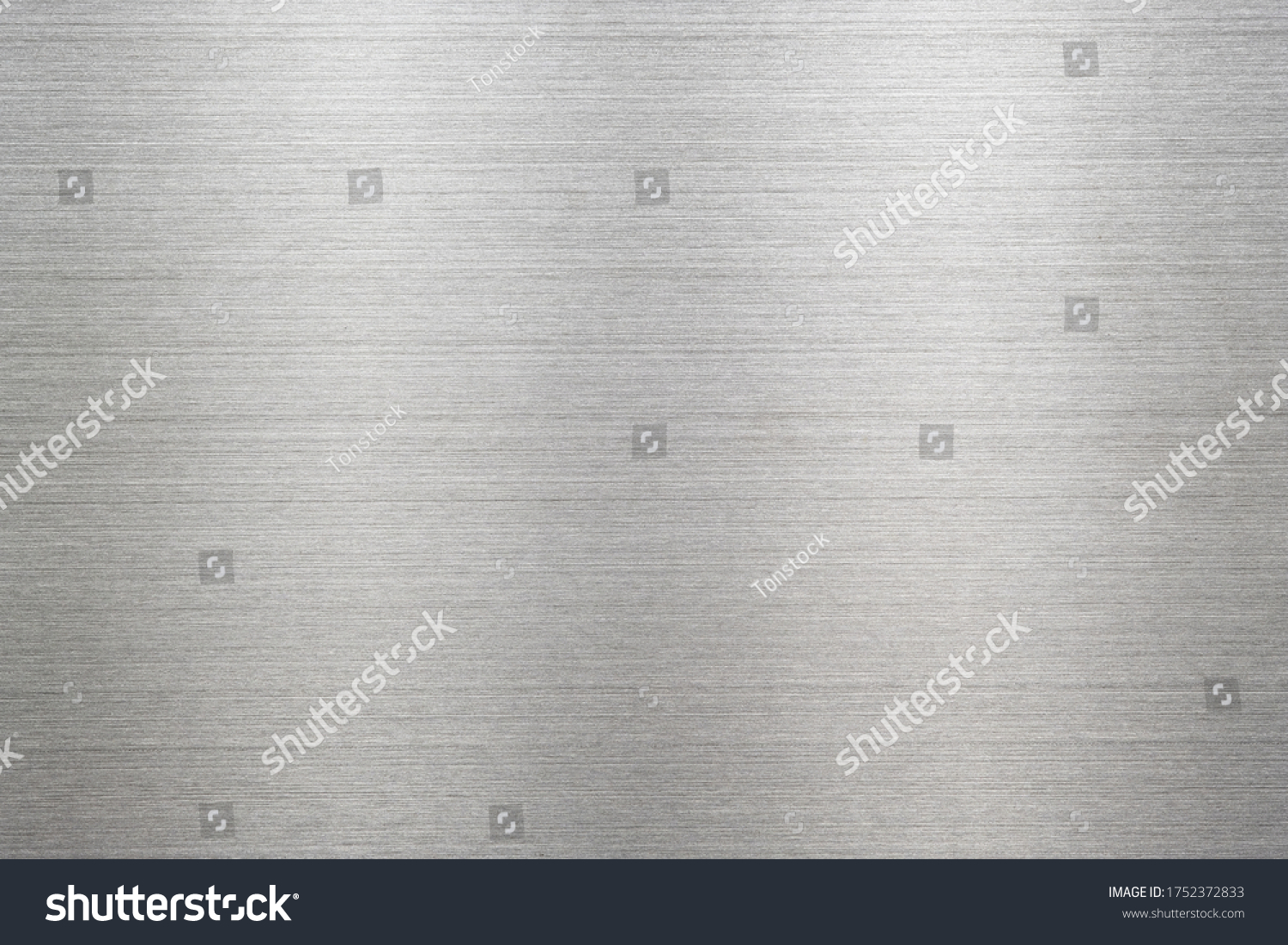 Abstract metal texture of brushed stainless steel plate with the reflection of light. #1752372833