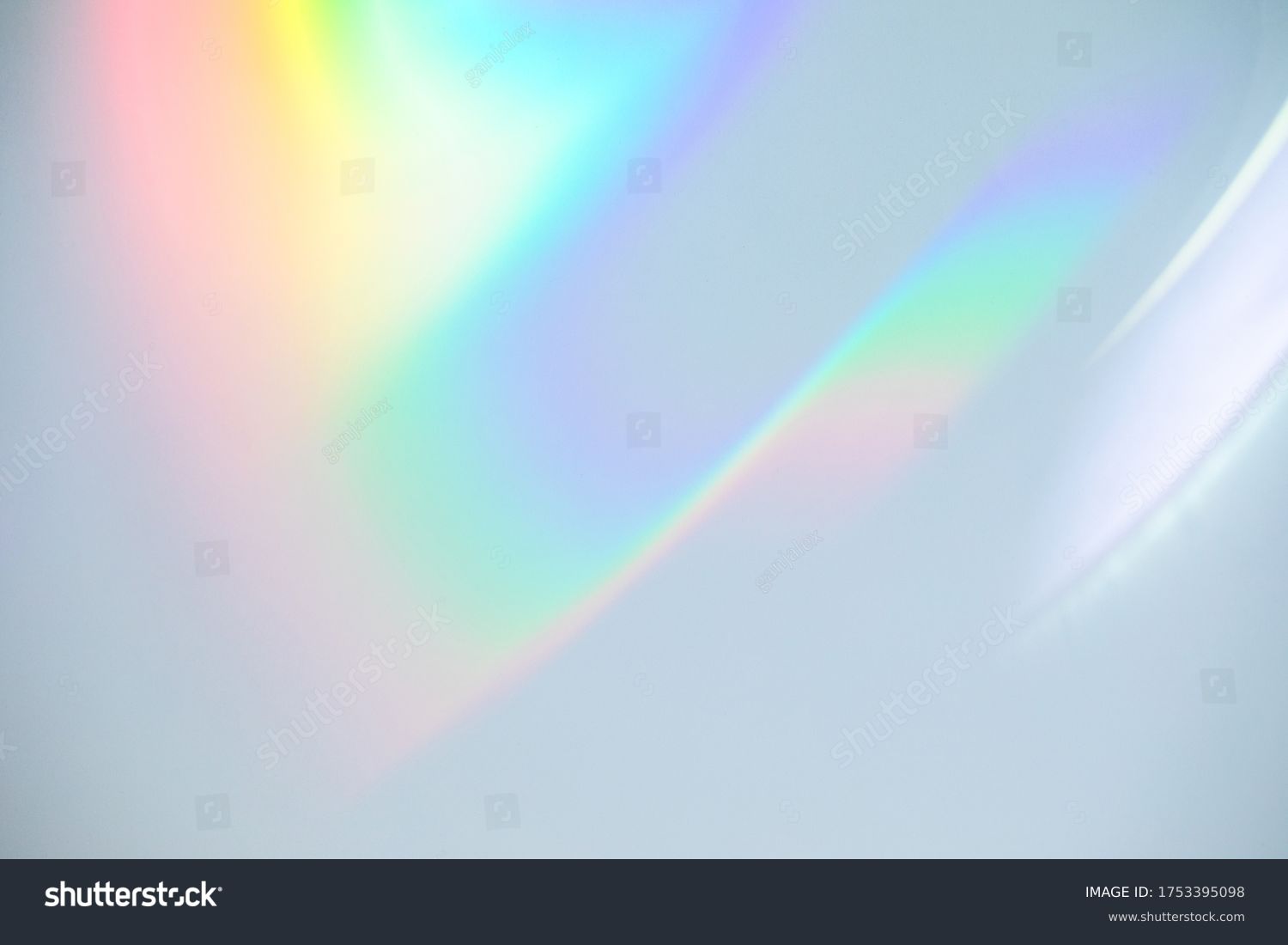 Blurred rainbow light refraction texture overlay effect for photo and mockups. Organic drop diagonal holographic flare on a white wall. Shadows for natural light effects #1753395098