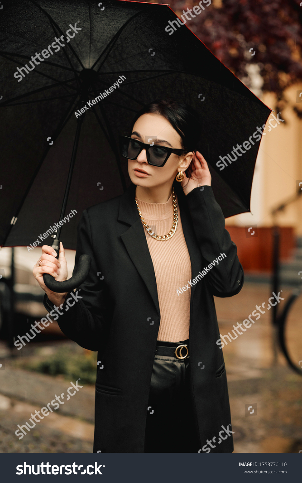Young girl makes emotion.Dressed in a black shirt, black sweater, black hat, glasses and bright lips, fashion clothes.Wear vintage sunglasses, outfit and hat, leisure style, bright colors.Sensual woma #1753770110