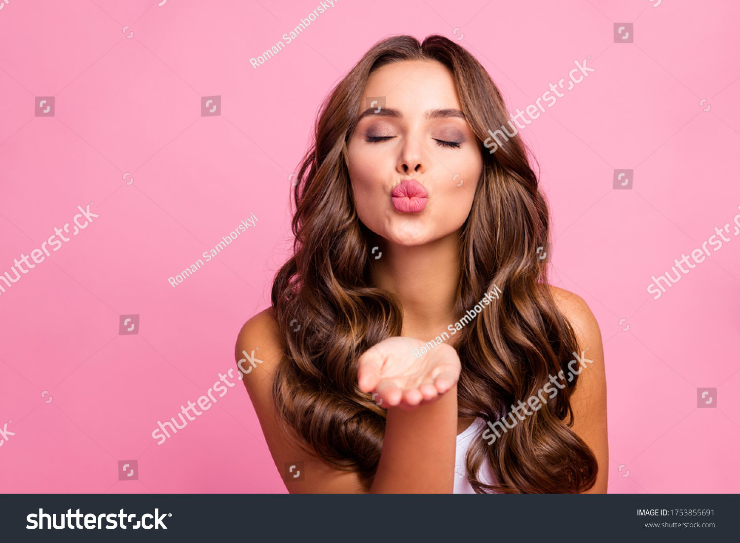 Just for you. Photo of pretty attractive curly lady send air kisses open palm flirting boyfriend tempting lips wear white casual singlet isolated bright pink color background #1753855691