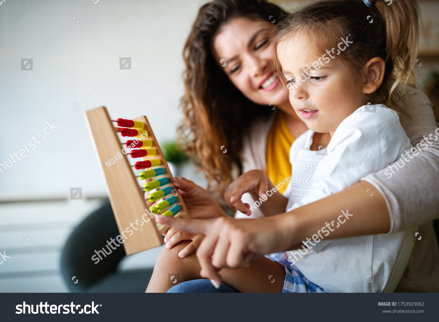 Mother and little cute girl, kid playing with abacus, early education #1753929062