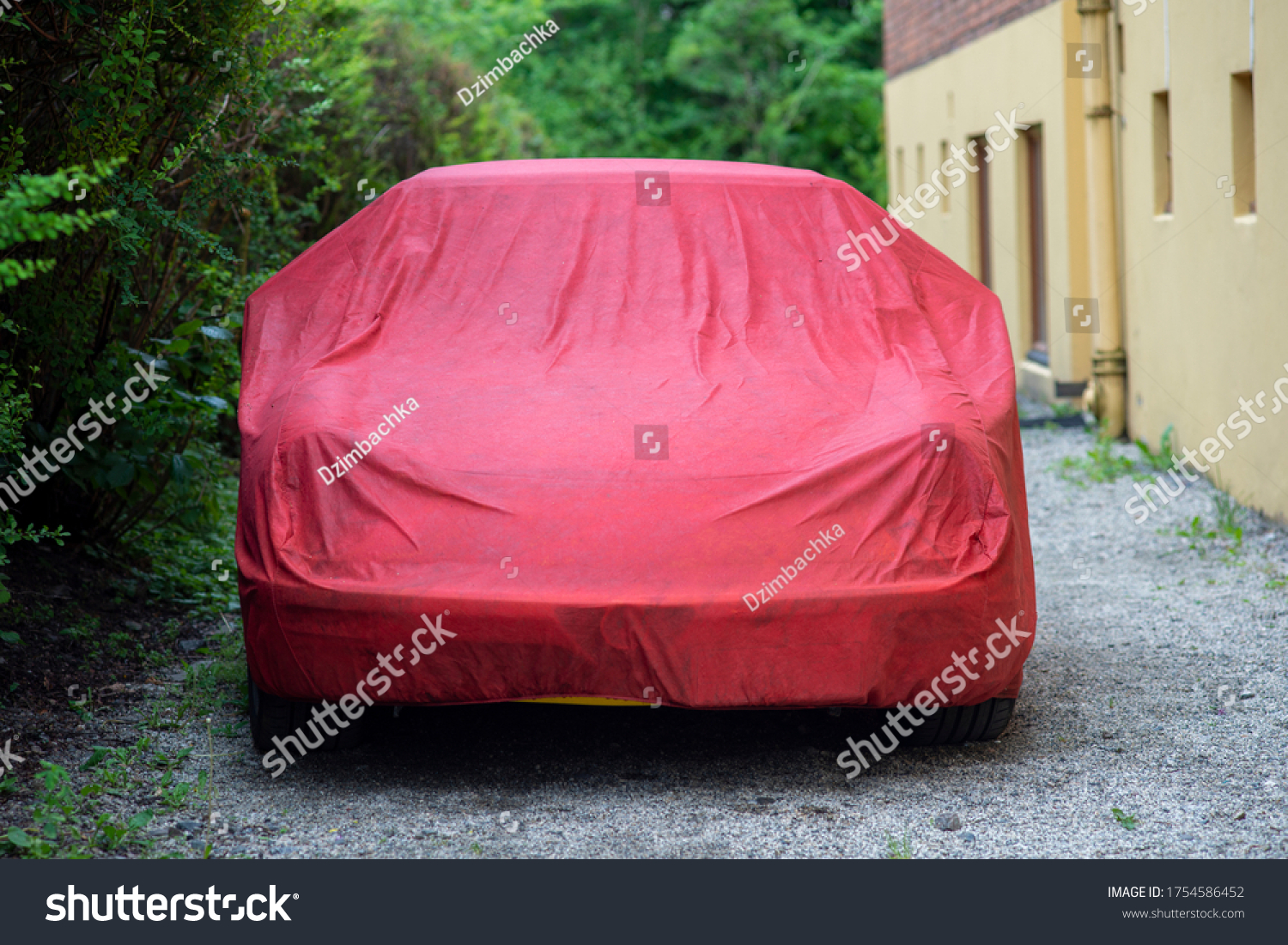 Yellow sport car under red Waterproof Car Cover parked on a gravel road. #1754586452