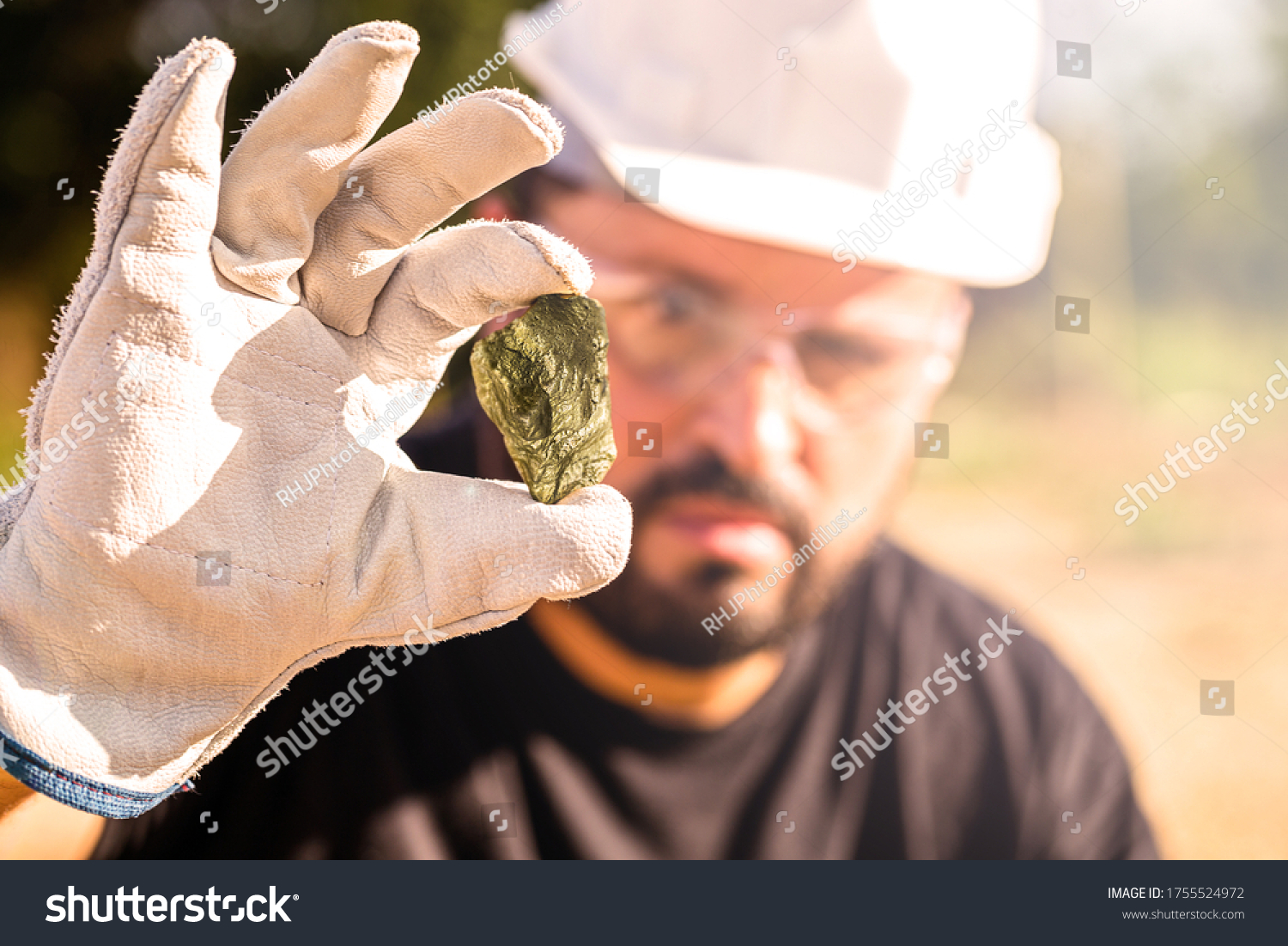 miner holding gold nugget, point focus on the gemstone. Mineral exploration concept, Minnesota, United States #1755524972