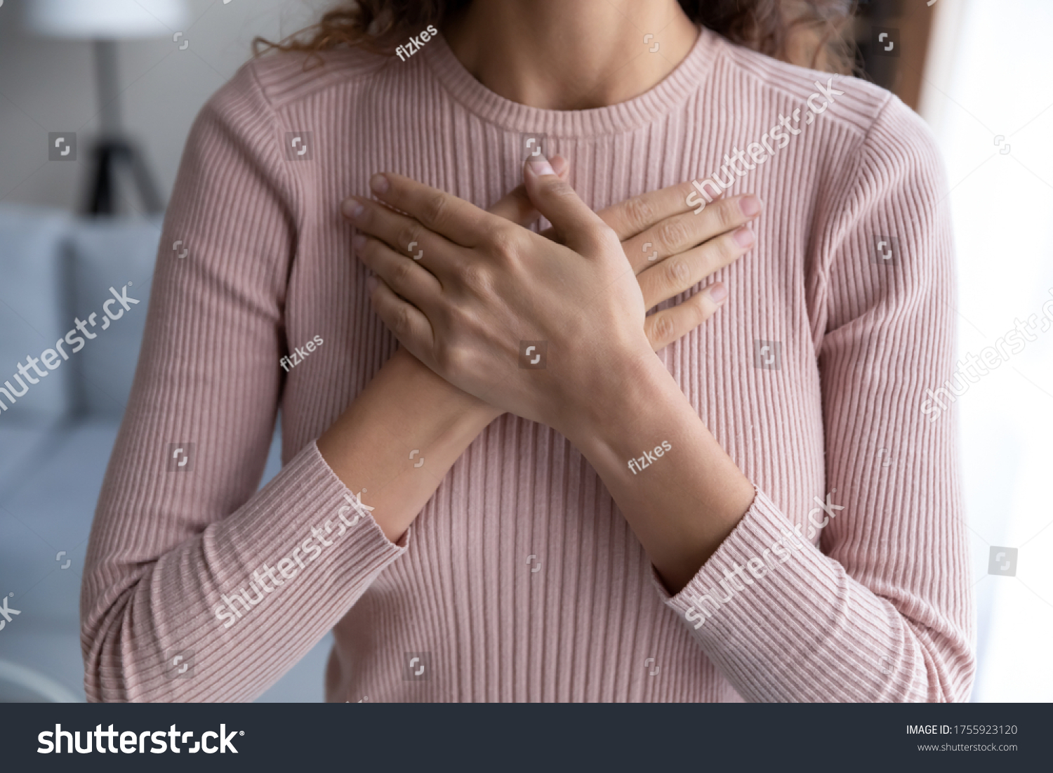 Close up hopeful grateful woman keeping hands on chest, dreamy young female thanking god and faith, feeling love, gratitude, appreciation, thinking dreaming about good future, making wish #1755923120
