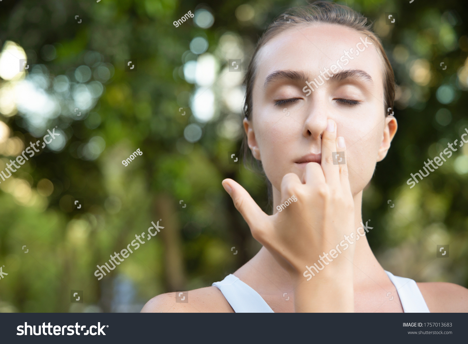 woman practicing yoga breathing technique, surya bheda pranayama, the sun breathing with one nostril #1757013683