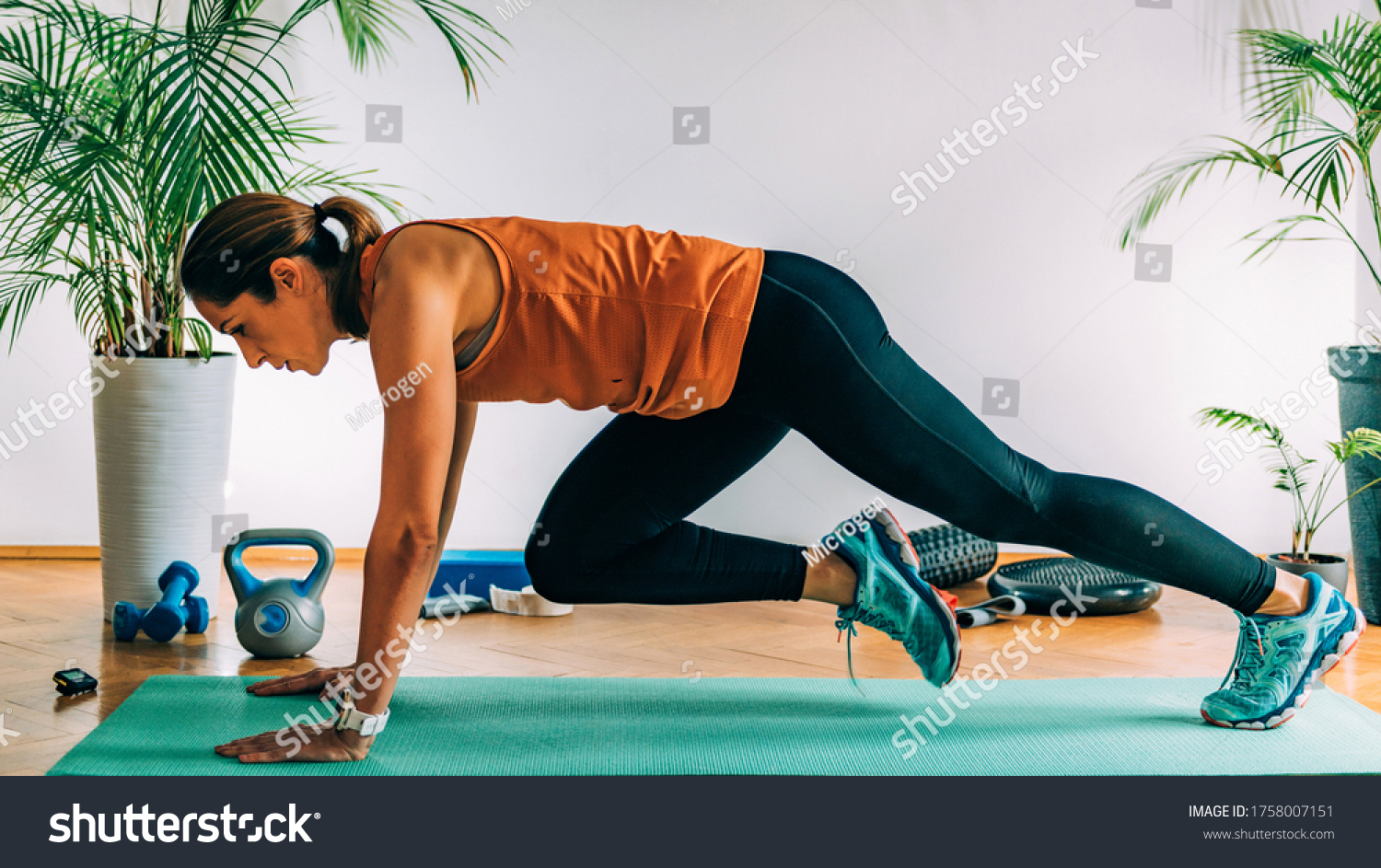 Mountain climbers, Woman Exercising Indoors, HIIT or high intensity interval training at home #1758007151