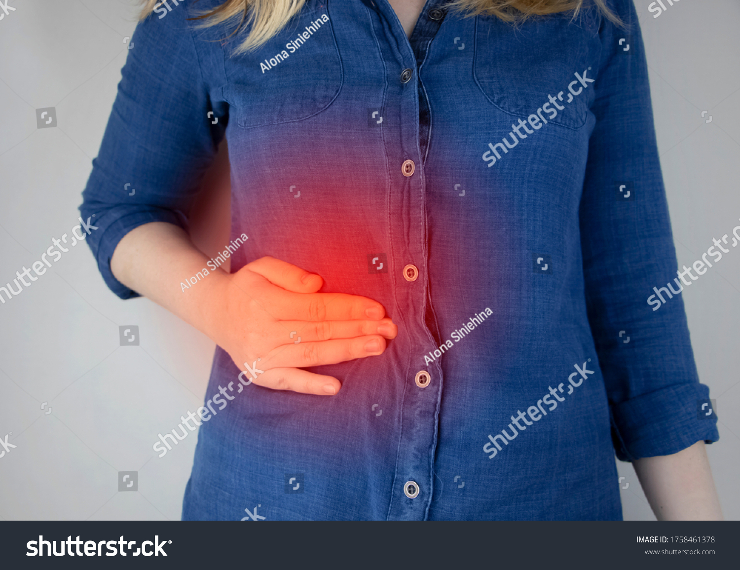 A woman grabs his right side under the ribs. Pain in the liver. Pain syndrome in liver disease. Hepatologist examination #1758461378