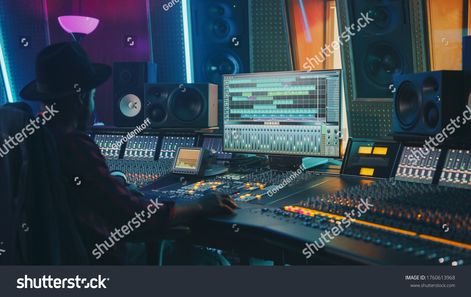 Portrait of Audio Engineer Working in Music Recording Studio, Uses Mixing Board Create Modern Sound. Successful Black Artist Musician Working at Control Desk. #1760613968