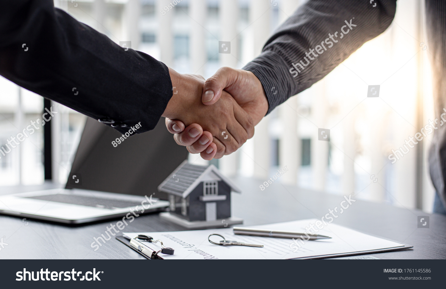 Real estate agents and customers shake hands to congratulate on signing a contract to buy a house with land and insurance, handshake and Good response concept. #1761145586