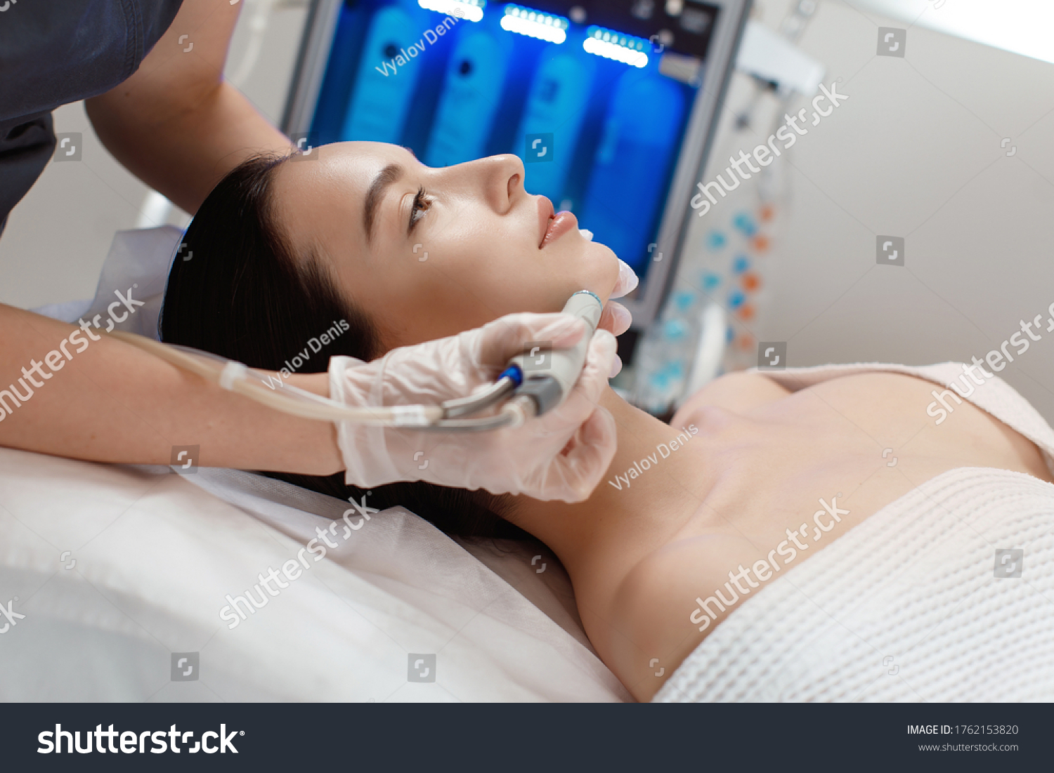 Professional female cosmetologist doing hydrafacial procedure in Cosmetology clinic. #1762153820